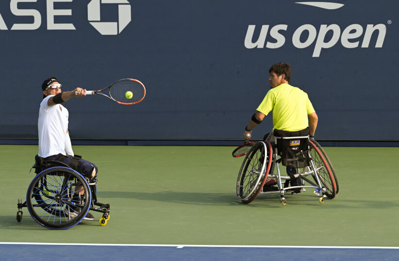 GUY SASSON of Israel competes with doubles partner Koji Sugeno of Japan during their first-round match at the US Open Quads event in Queens, New York. (photo credit: USTA/COURTESY)
